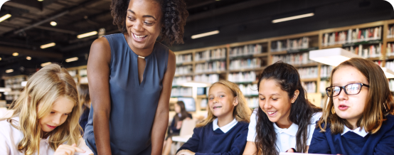 Teacher with students in a library